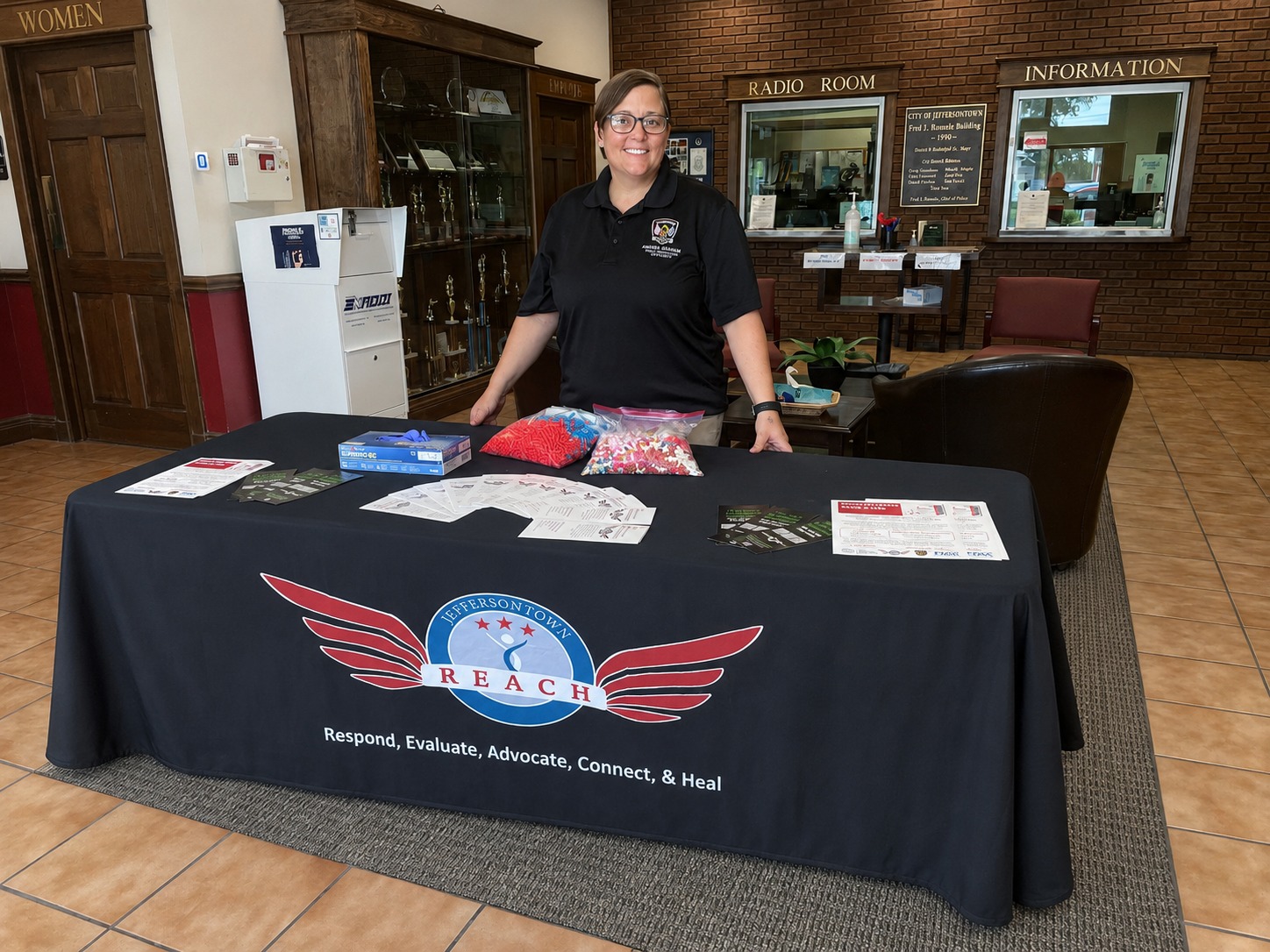 Amanda Chapman at a REACH information table with program resources